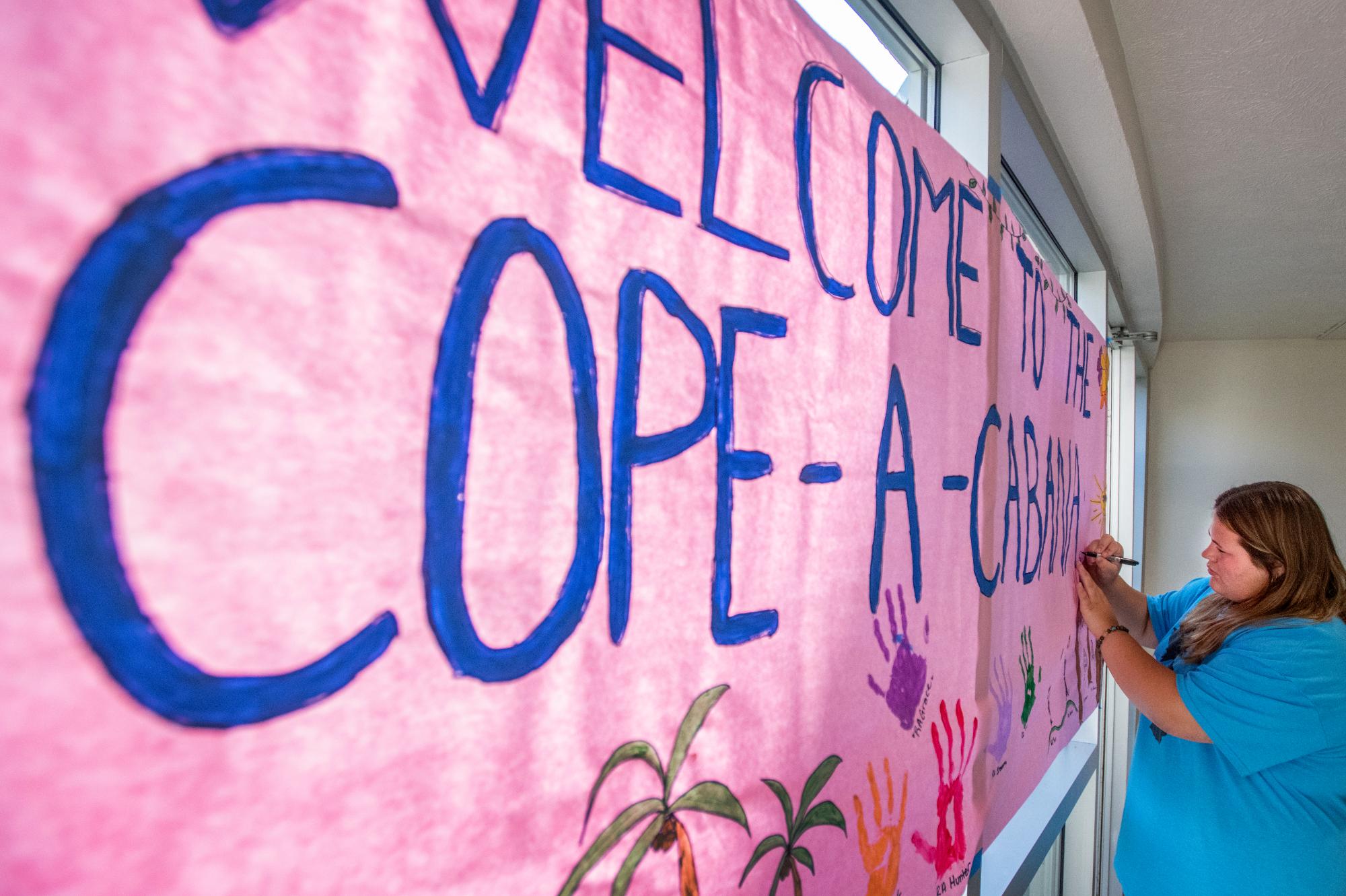 An RA decorating a housing bullitenboard